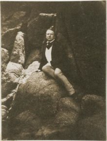 Victor Hugo sitting on the “Rock of Exiles” on the island of Jersey