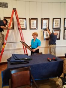 Here is Marva helping the UVa Facilities Management team put up the frames. 